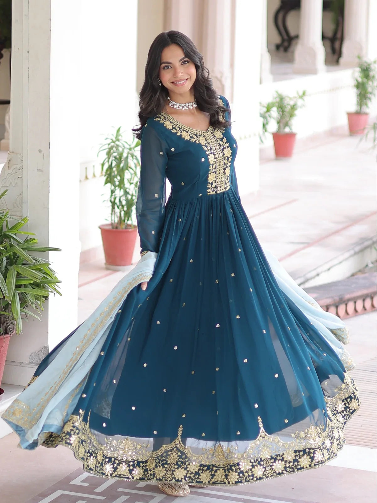 Tarani teal embroidered gown with flowy flare and elegant dupatta for festive wear
