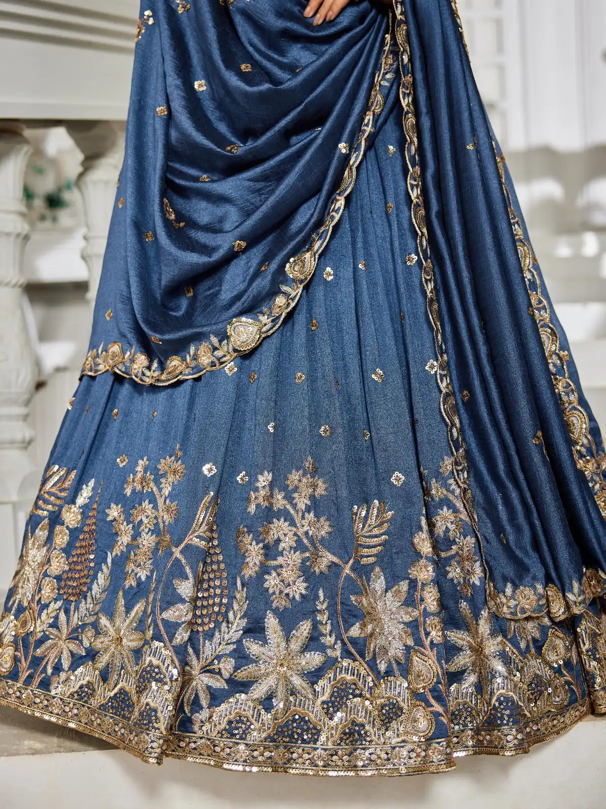 Tarani closeup of golden embroidery and detailing on blue georgette lehenga