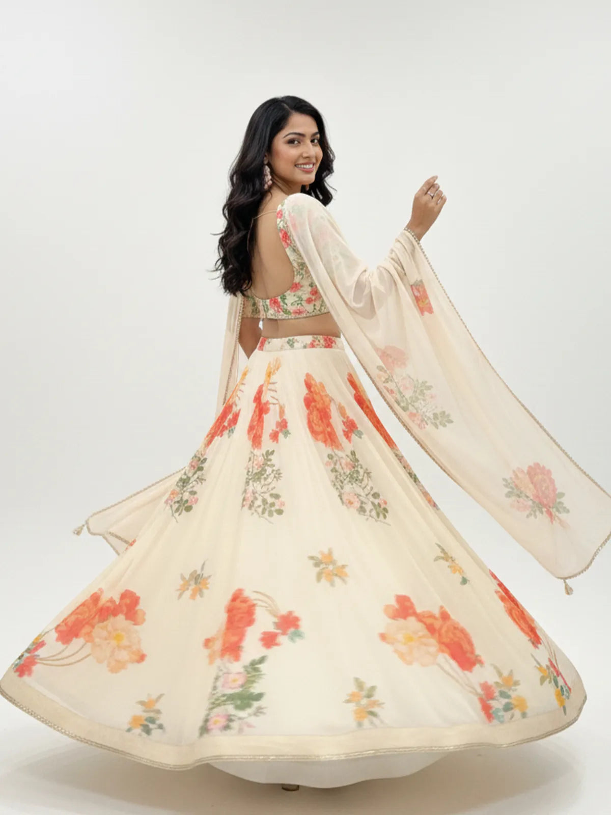 Tarani floral georgette lehenga with open back blouse and flowing dupatta shown in graceful back view