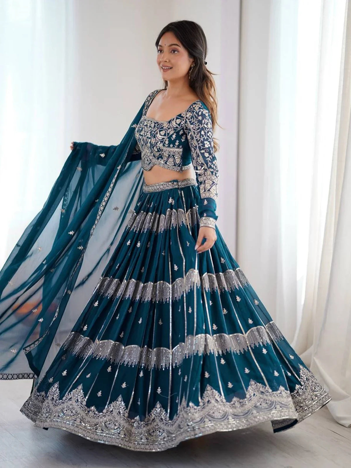 Tarani teal embroidered lehenga front view showing blouse sleeve design and flare detailing