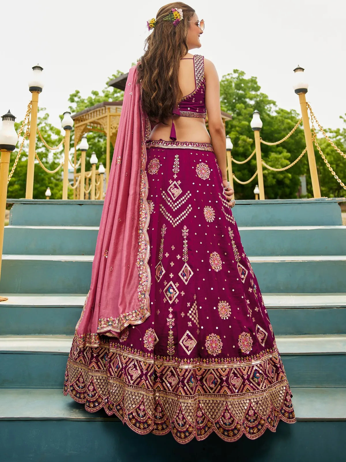 Tarani magenta georgette lehenga back view with embroidered blouse and dupatta fall