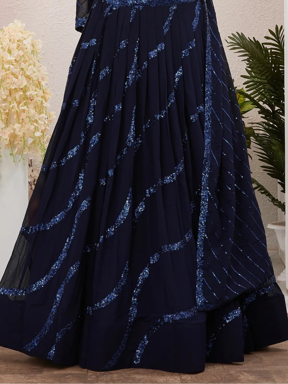Tarani closeup view of navy blue lehenga showcasing sequin detailing and fabric texture