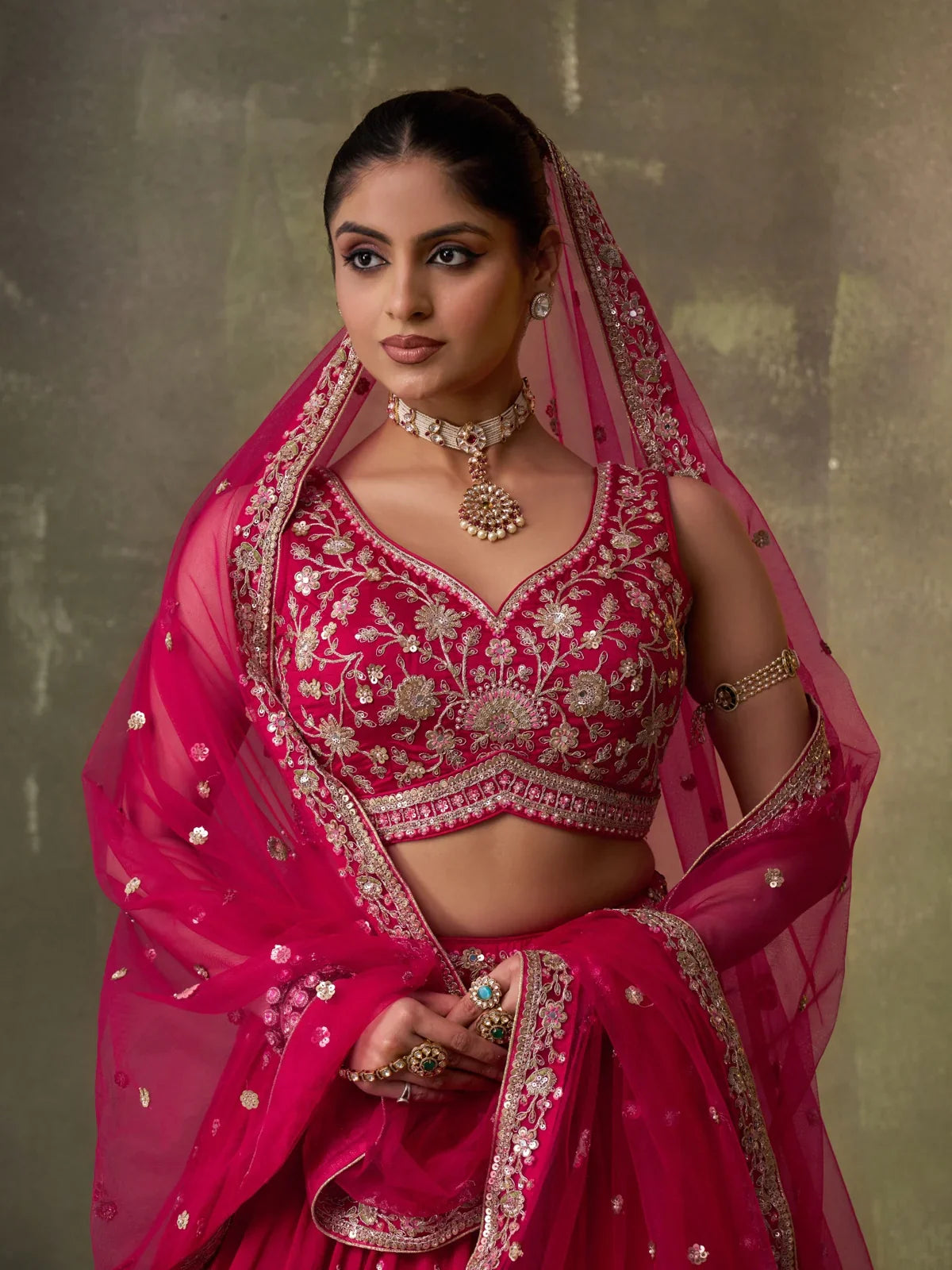 Tarani festive pink lehenga set with detailed embroidery, upper body view showing blouse neckline and jewellery