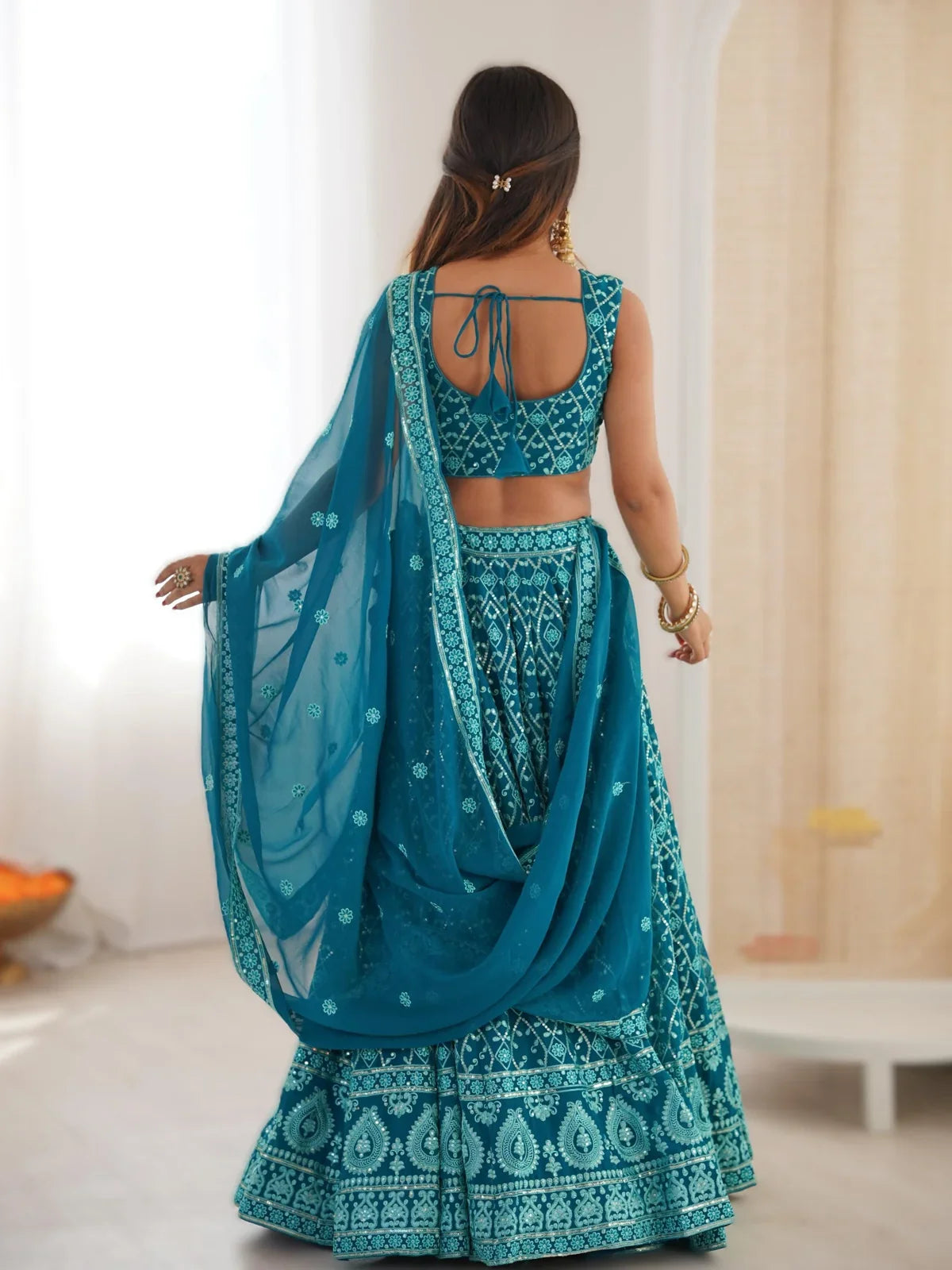 Back view of Tarani teal lehenga with designer tied blouse and draped dupatta