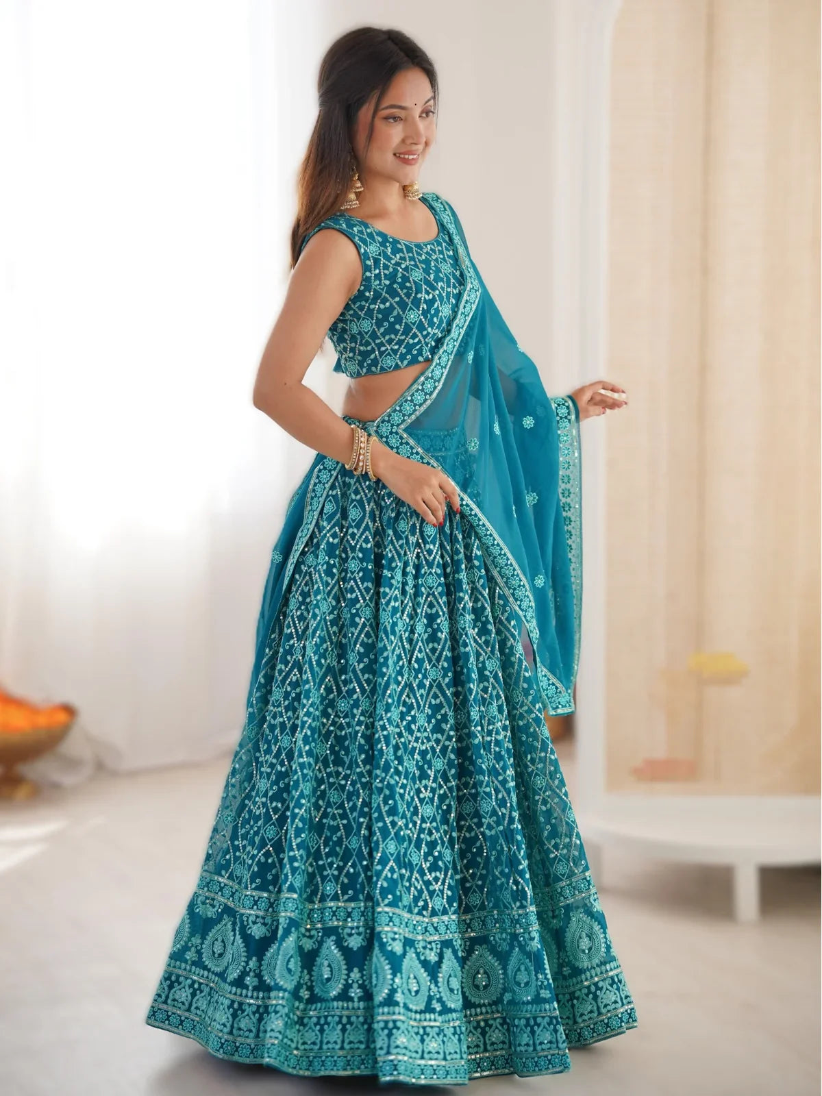 Tarani teal lehenga front pose with sequins embroidery and elegant styling