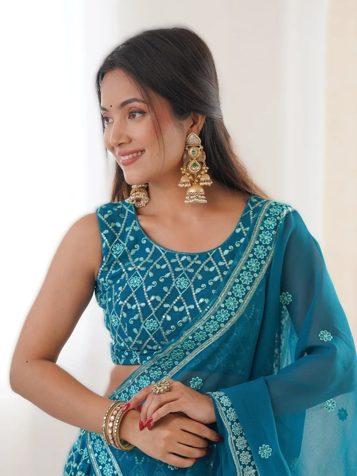 Tarani festive teal lehenga with sleeveless blouse and gold crush dupatta upper body view