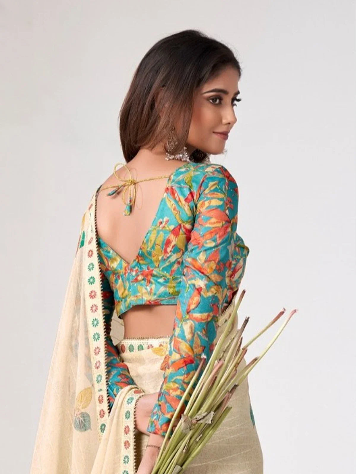 Tarani saree back view highlighting blouse tie-up and embroidered border detail