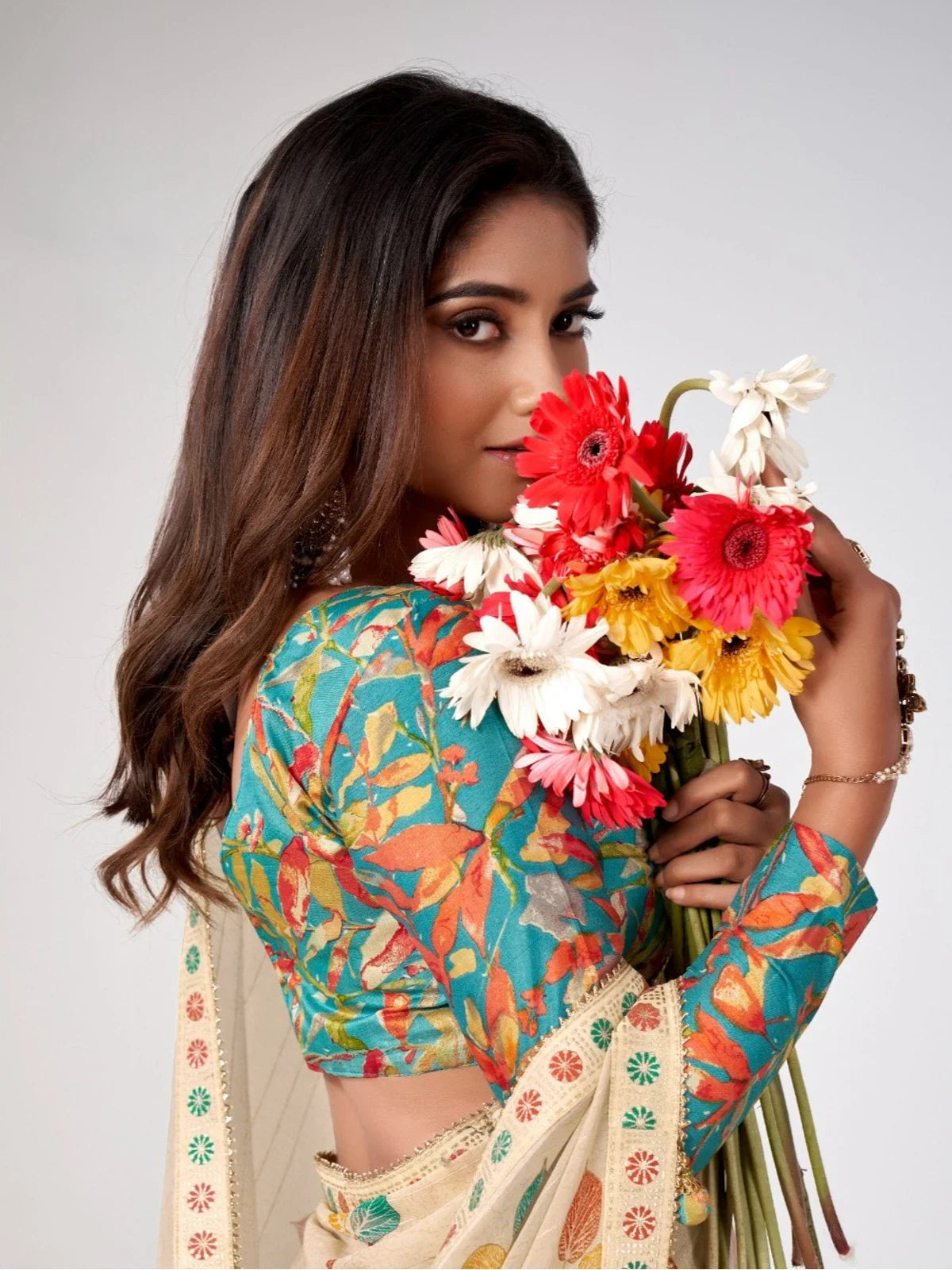 Tarani beige georgette saree upper body view showing floral silk blend blouse with earrings