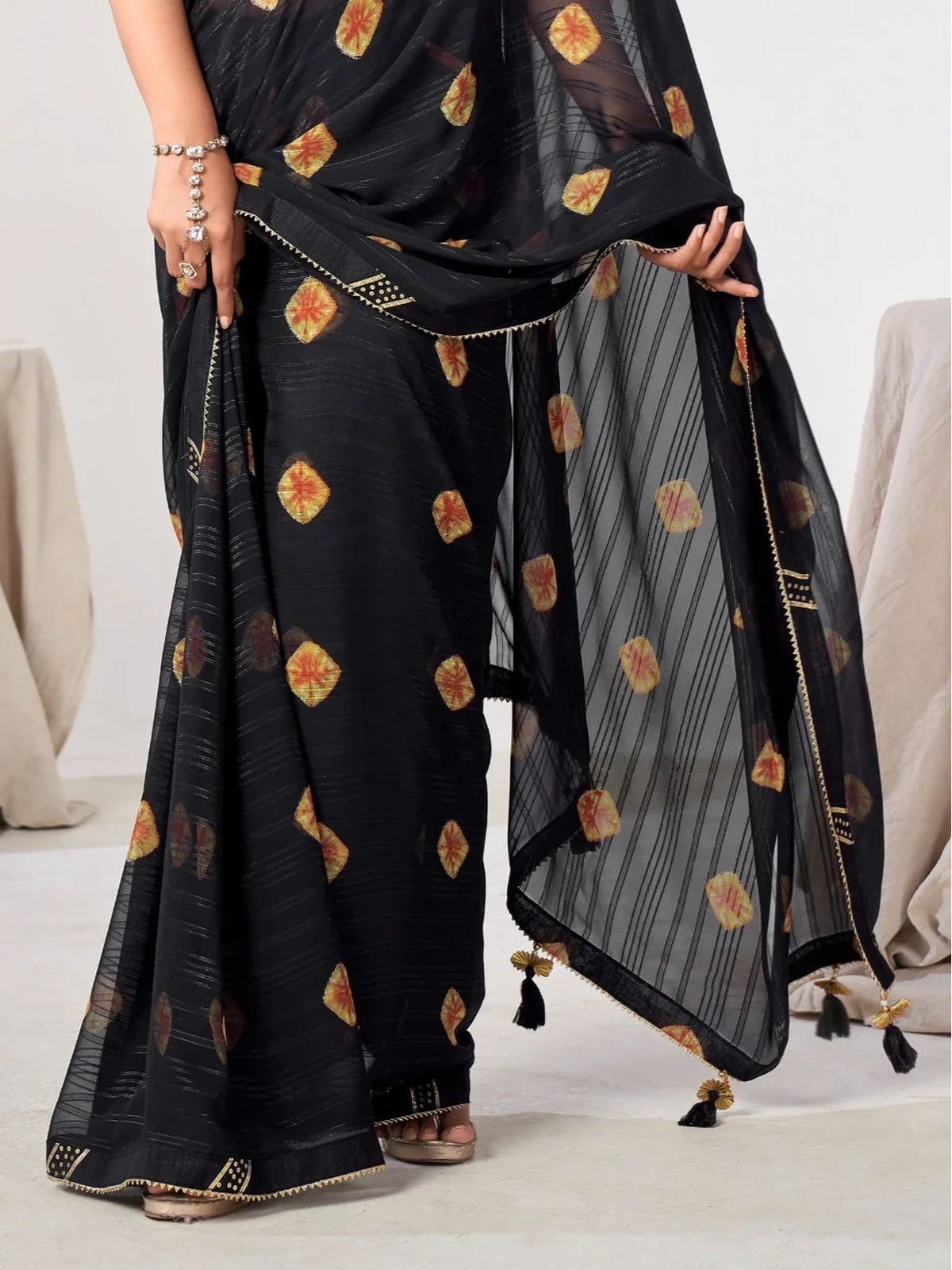 Tarani black georgette saree border and tassel detailing perfect for evening festive gatherings