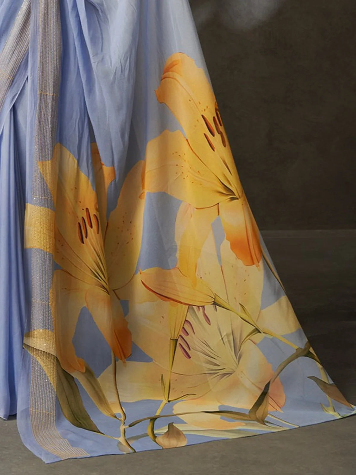 Tarani blue georgette saree close-up showing elegant flower detailing and shimmer border