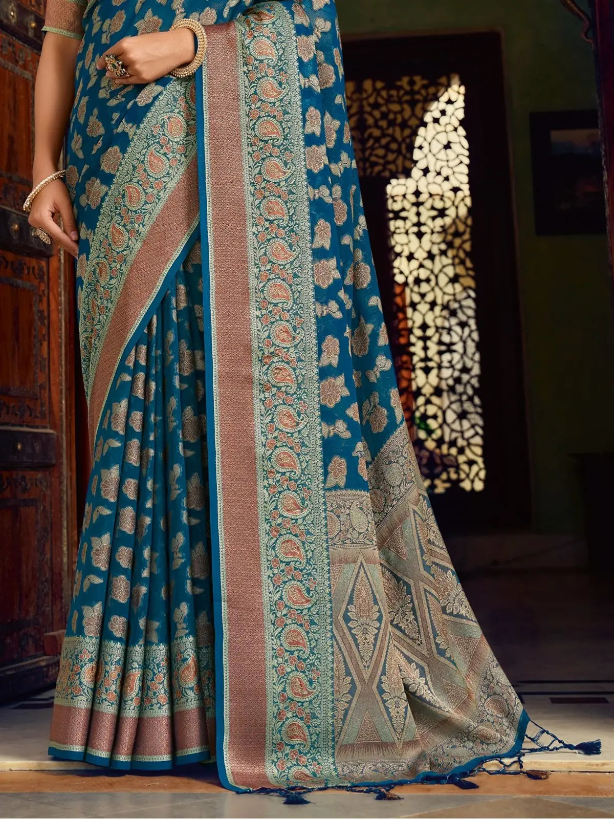 Tarani premium blue georgette saree with rich woven pallu and intricate border design