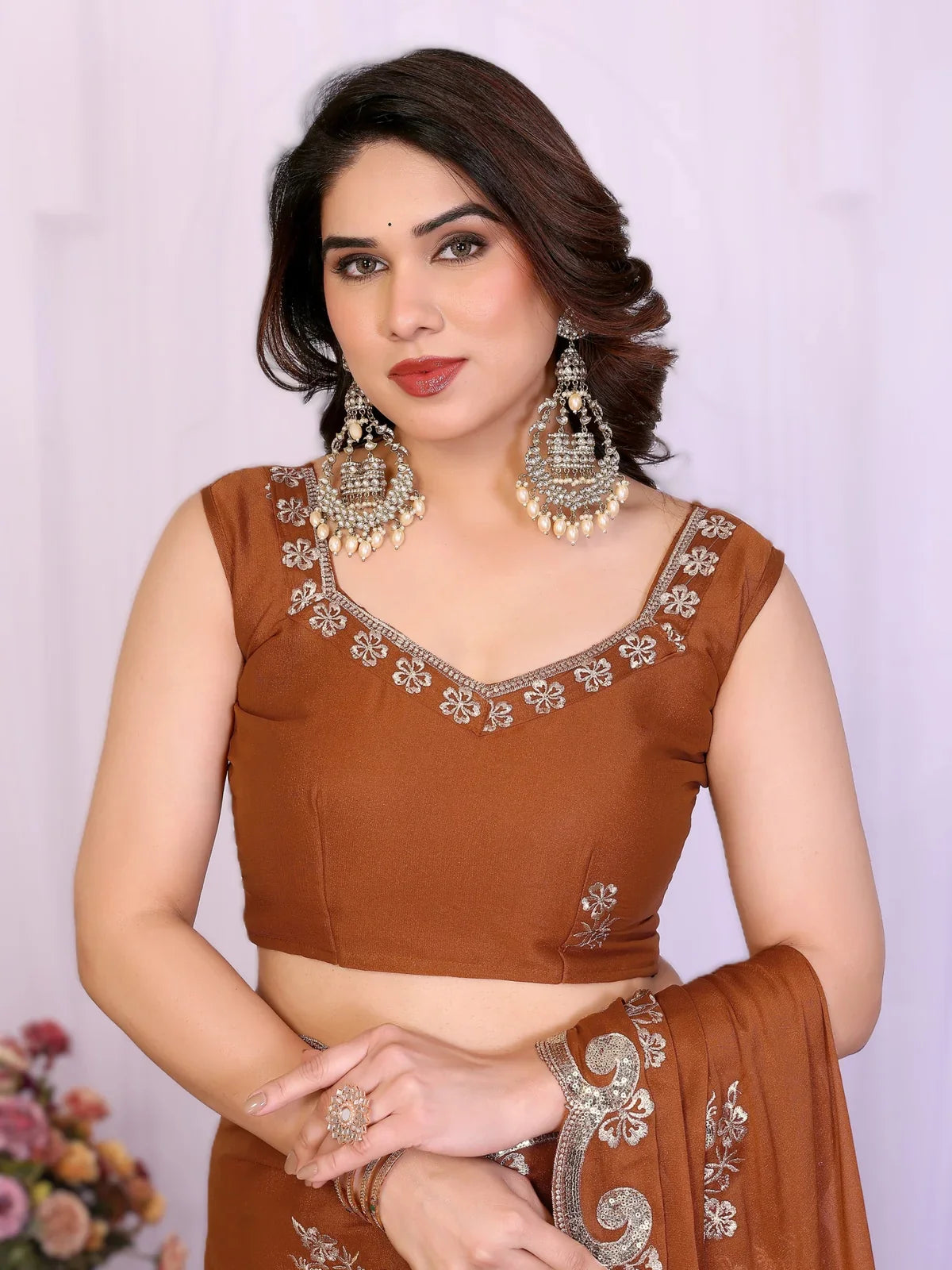 Tarani brown georgette saree close-up showing designer blouse and jewellery
