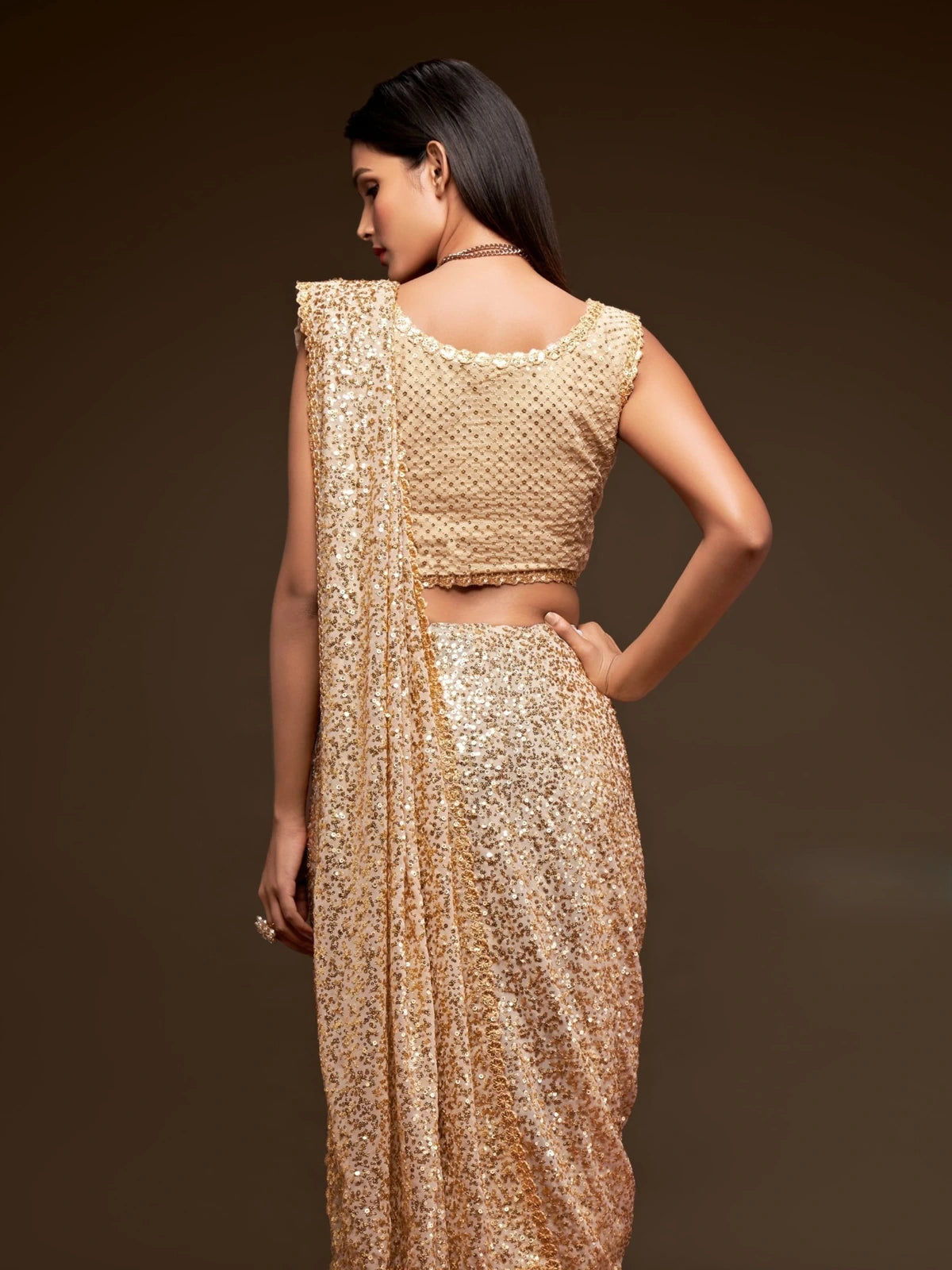 Tarani golden georgette saree back view showcasing embroidered blouse design and drape