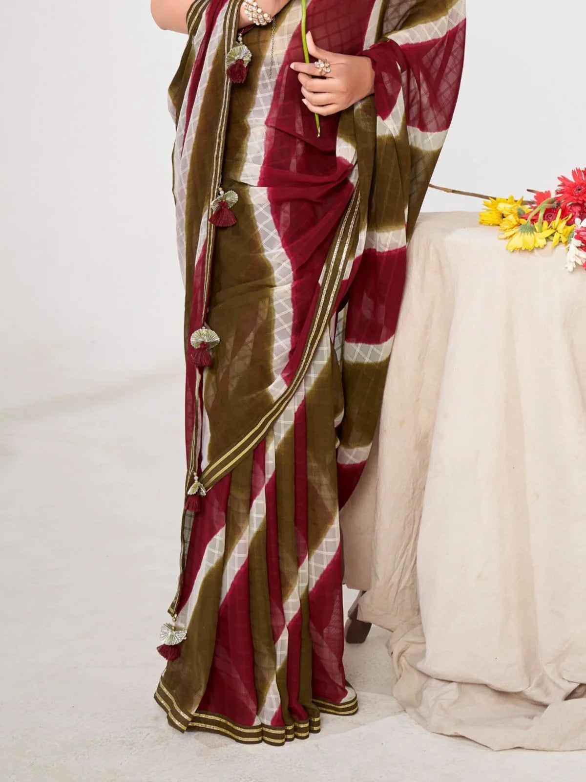 Tarani closeup view of maroon and olive georgette saree fabric texture with silk blend detailing
