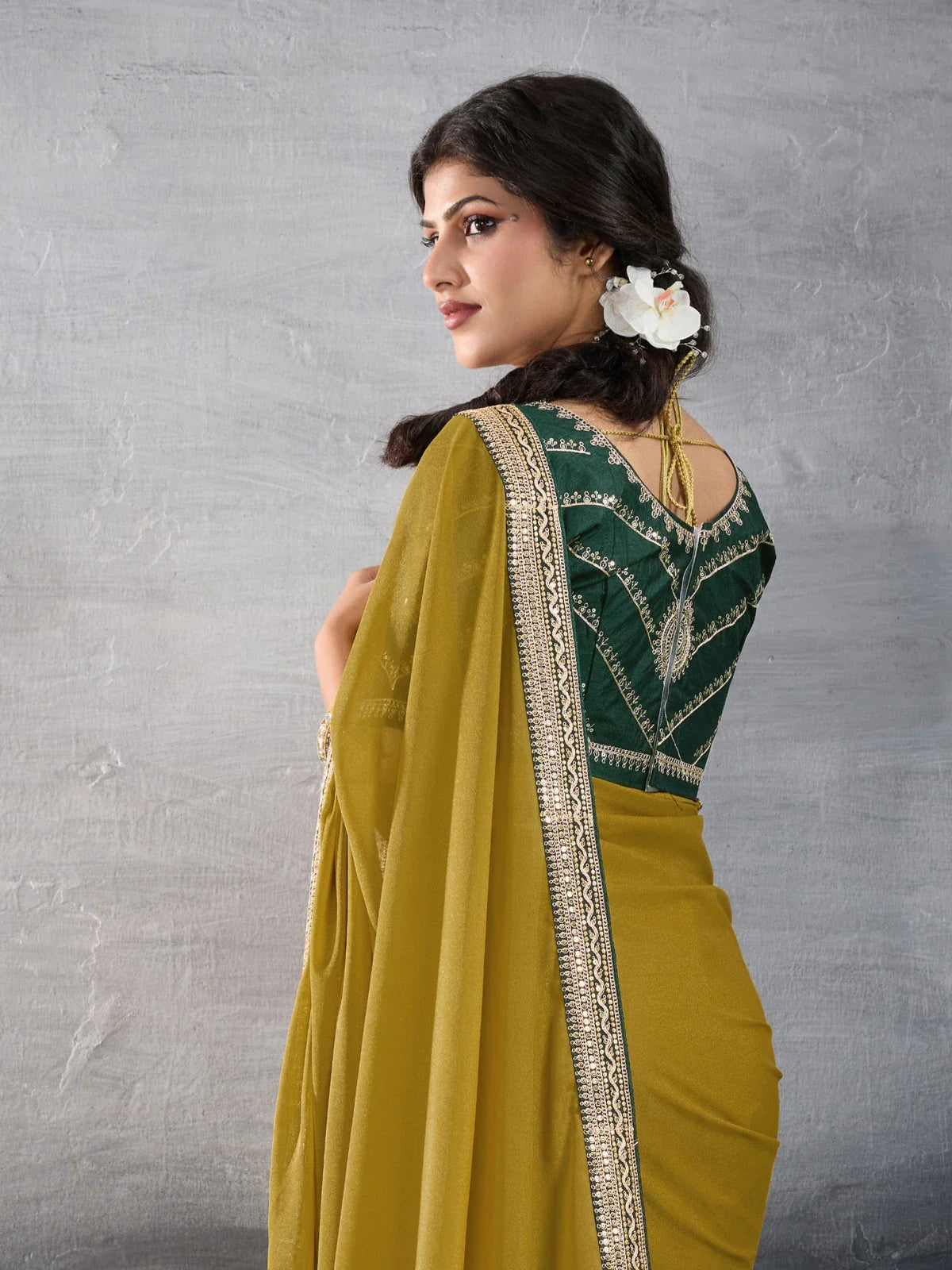 Tarani mustard georgette saree back view with embroidered blouse for festive and party wear