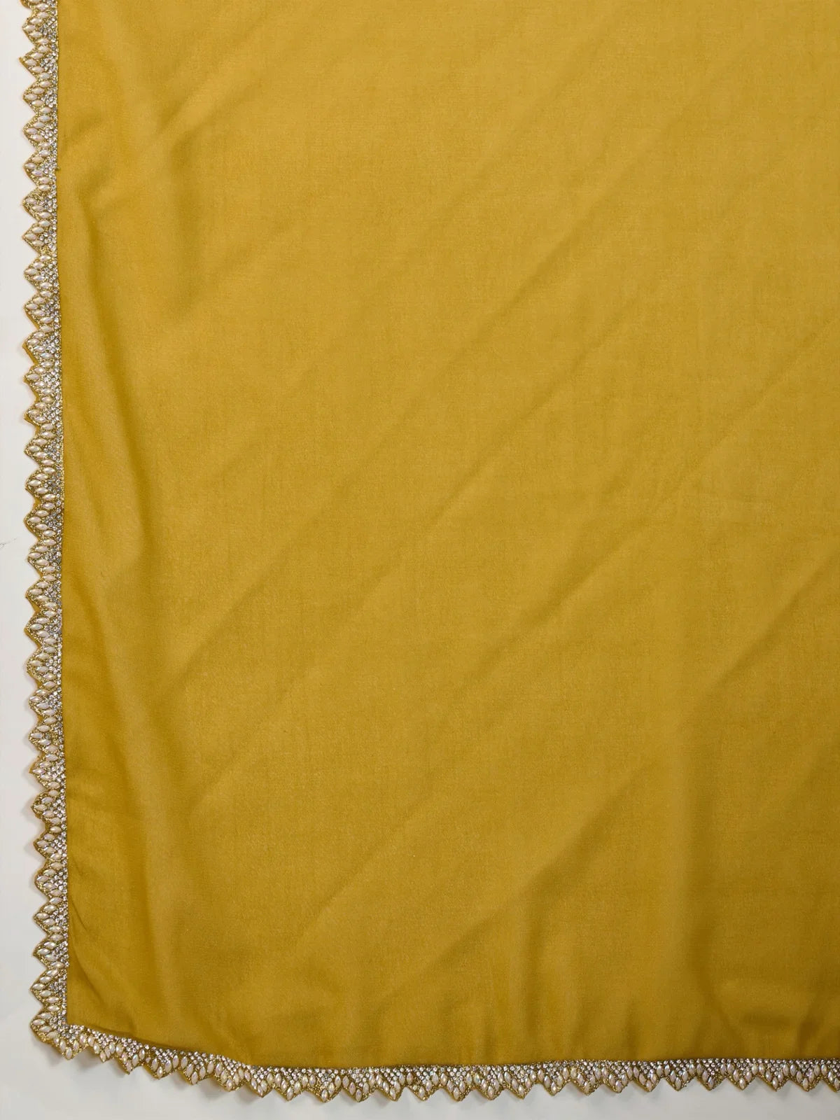 Tarani mustard georgette saree fabric with ceramic-inspired lace detailing closeup