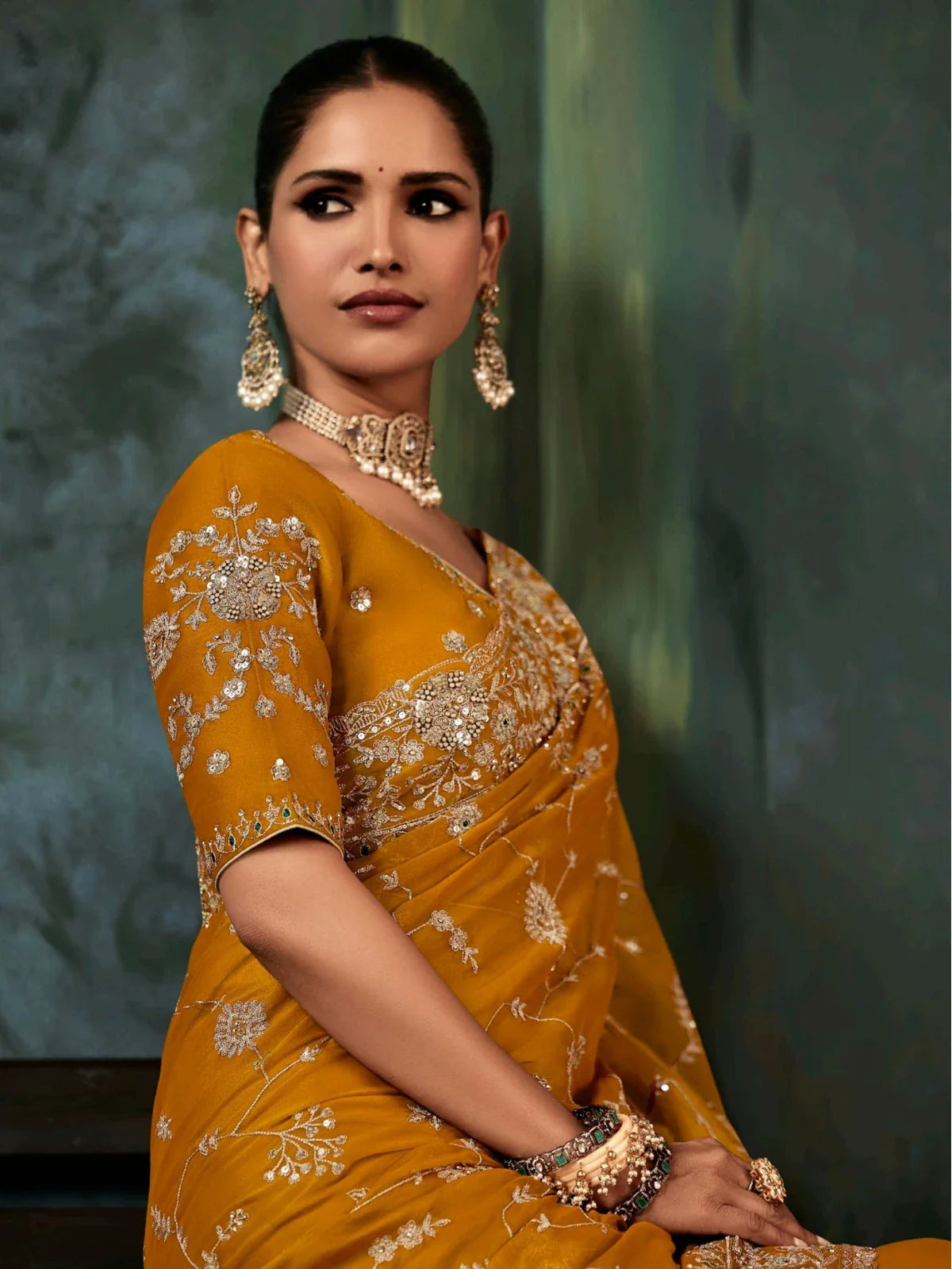 Tarani mustard georgette saree upper body view showing blouse embroidery and jewellery style