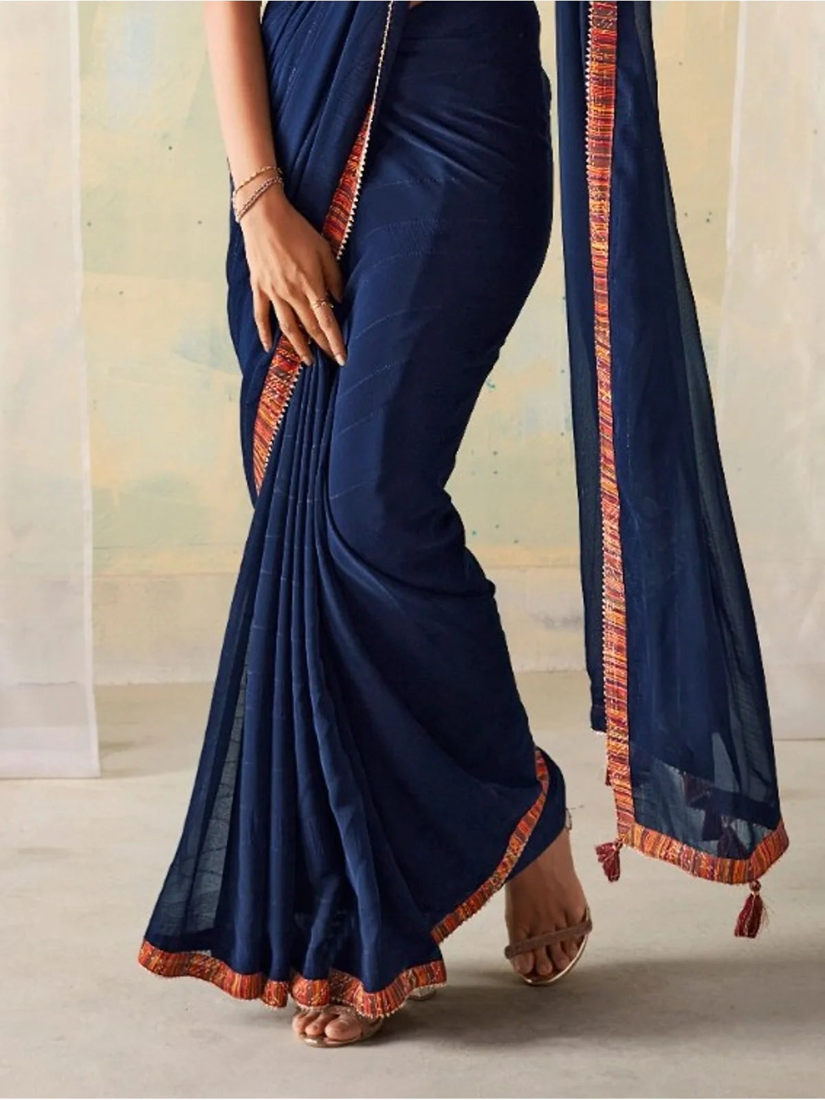 Tarani closeup view of navy blue georgette saree showing fabric detailing and contrast border
