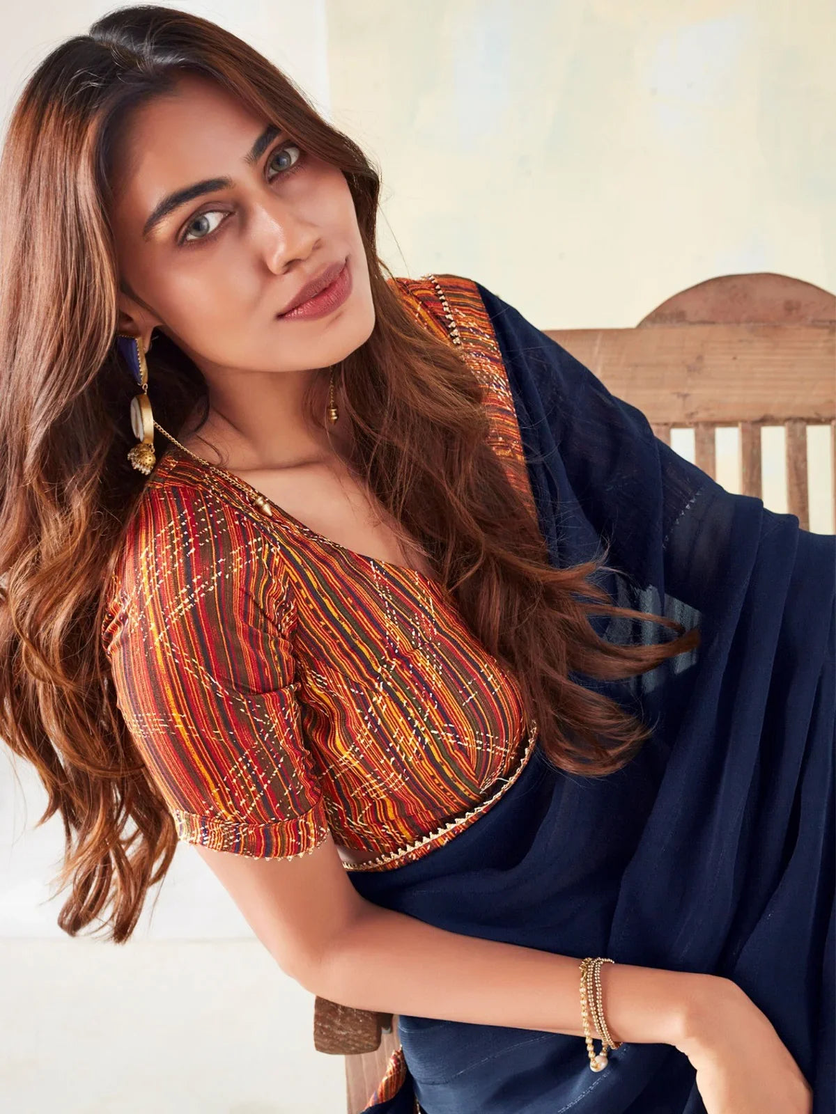 Tarani elegant navy blue georgette saree upper body view highlighting woven border and printed blouse