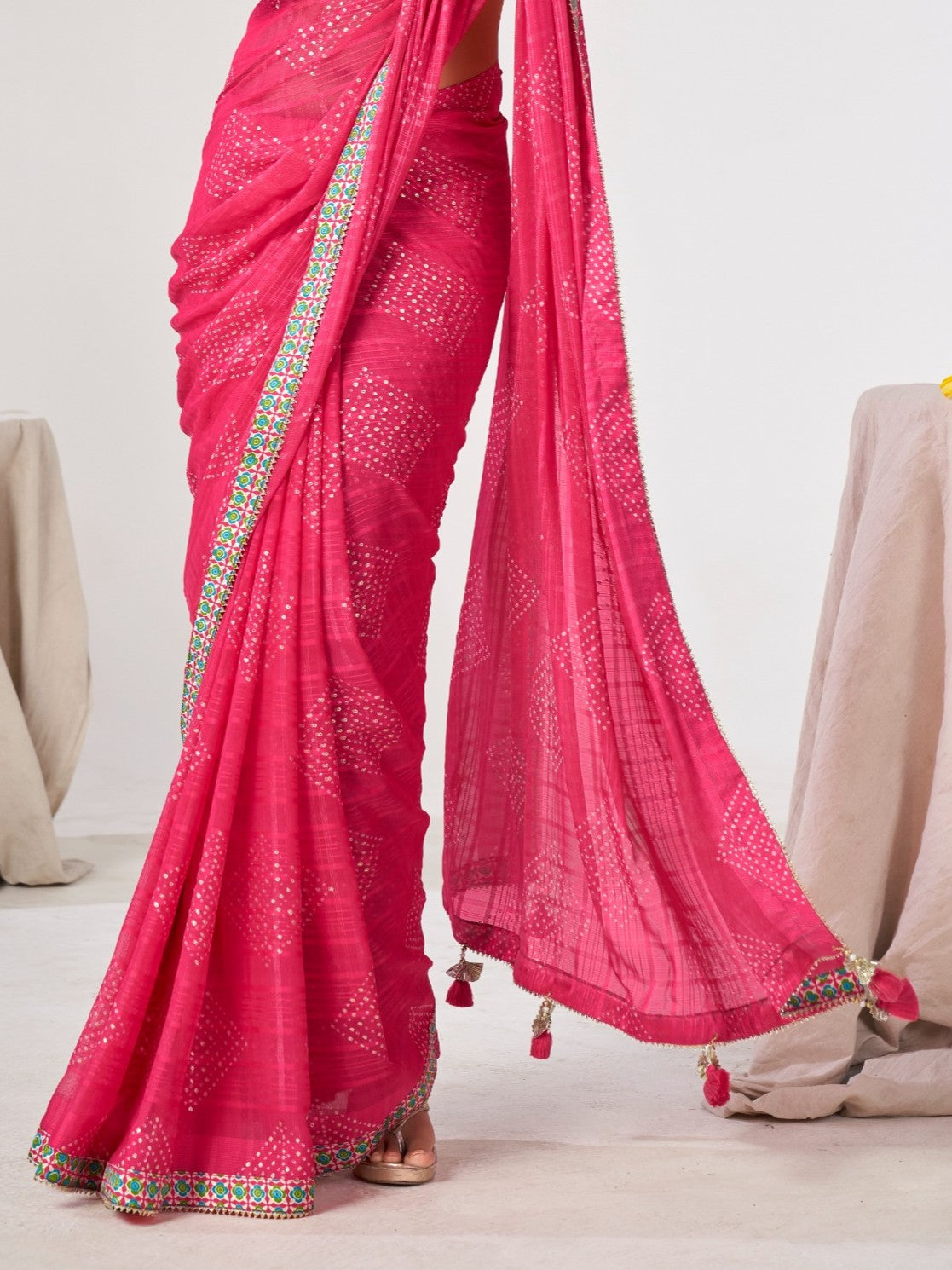 Tarani pink georgette saree pallu view showing tassels and intricate border detailing