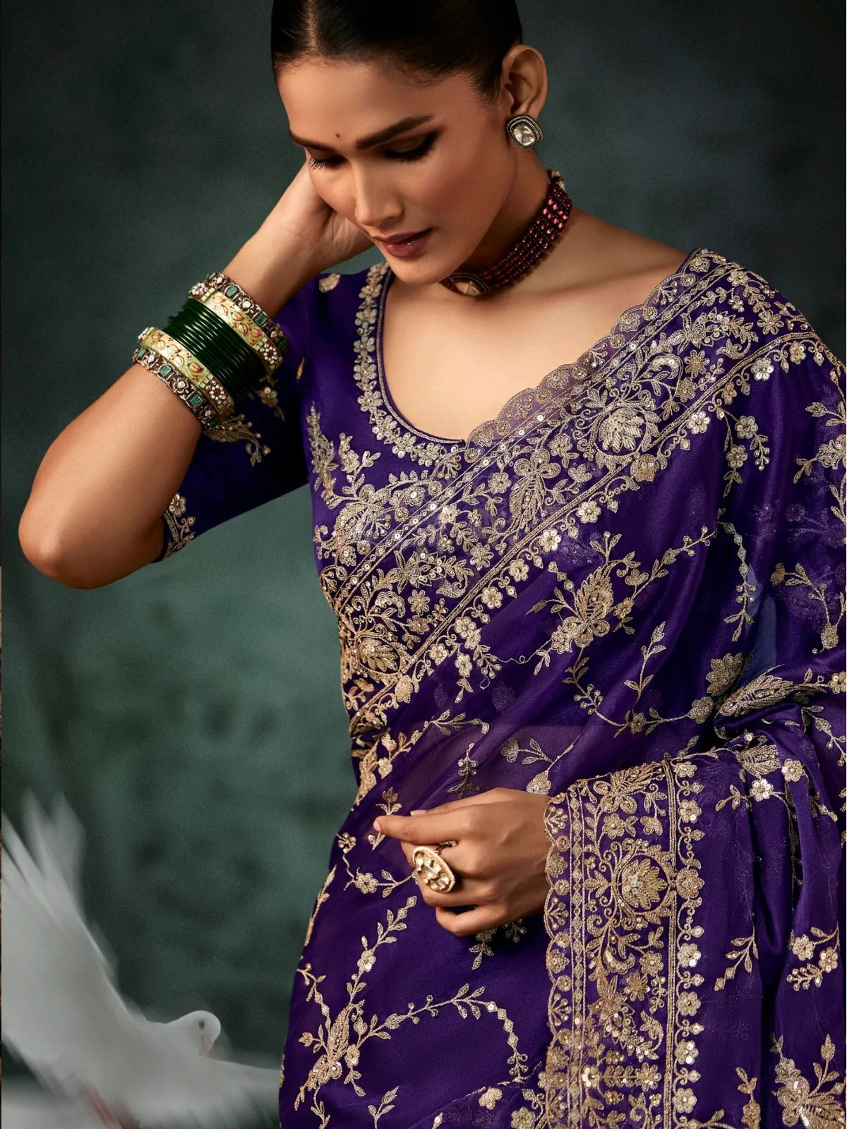 Tarani embroidered purple georgette saree showing upper body and neckline blouse details