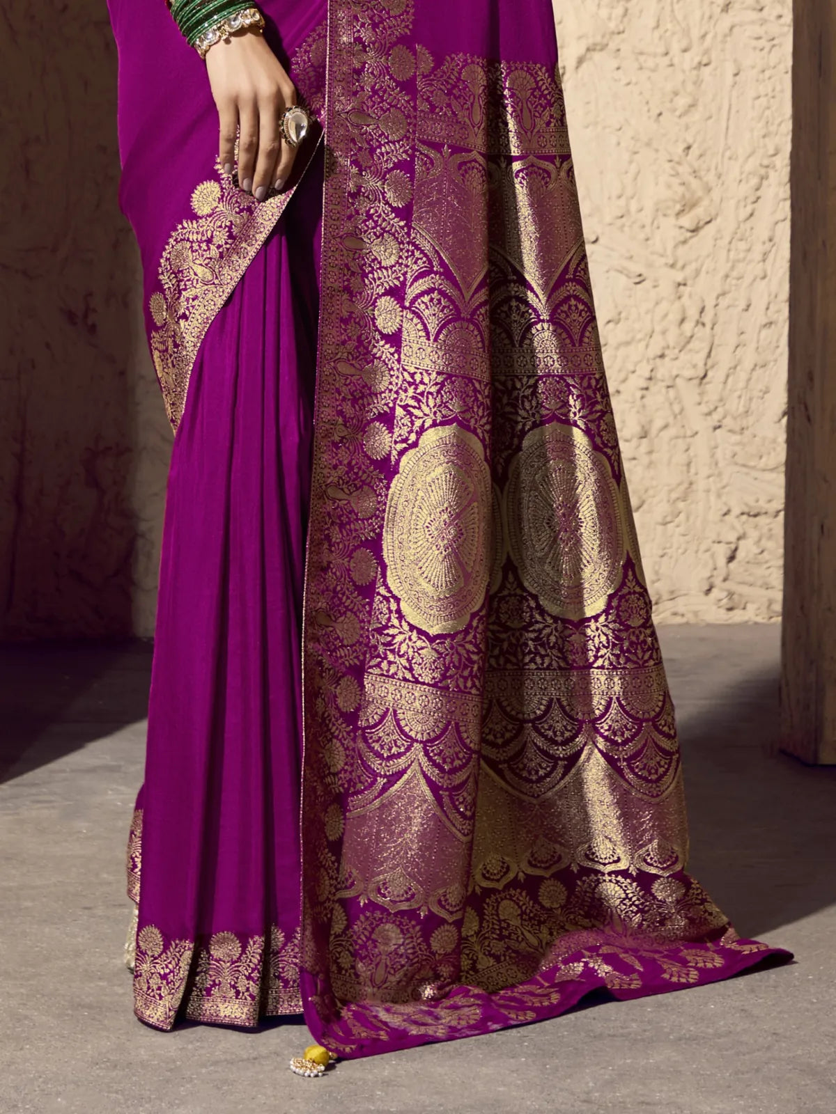 Tarani georgette saree lower half closeup highlighting golden zari weaving on purple fabric
