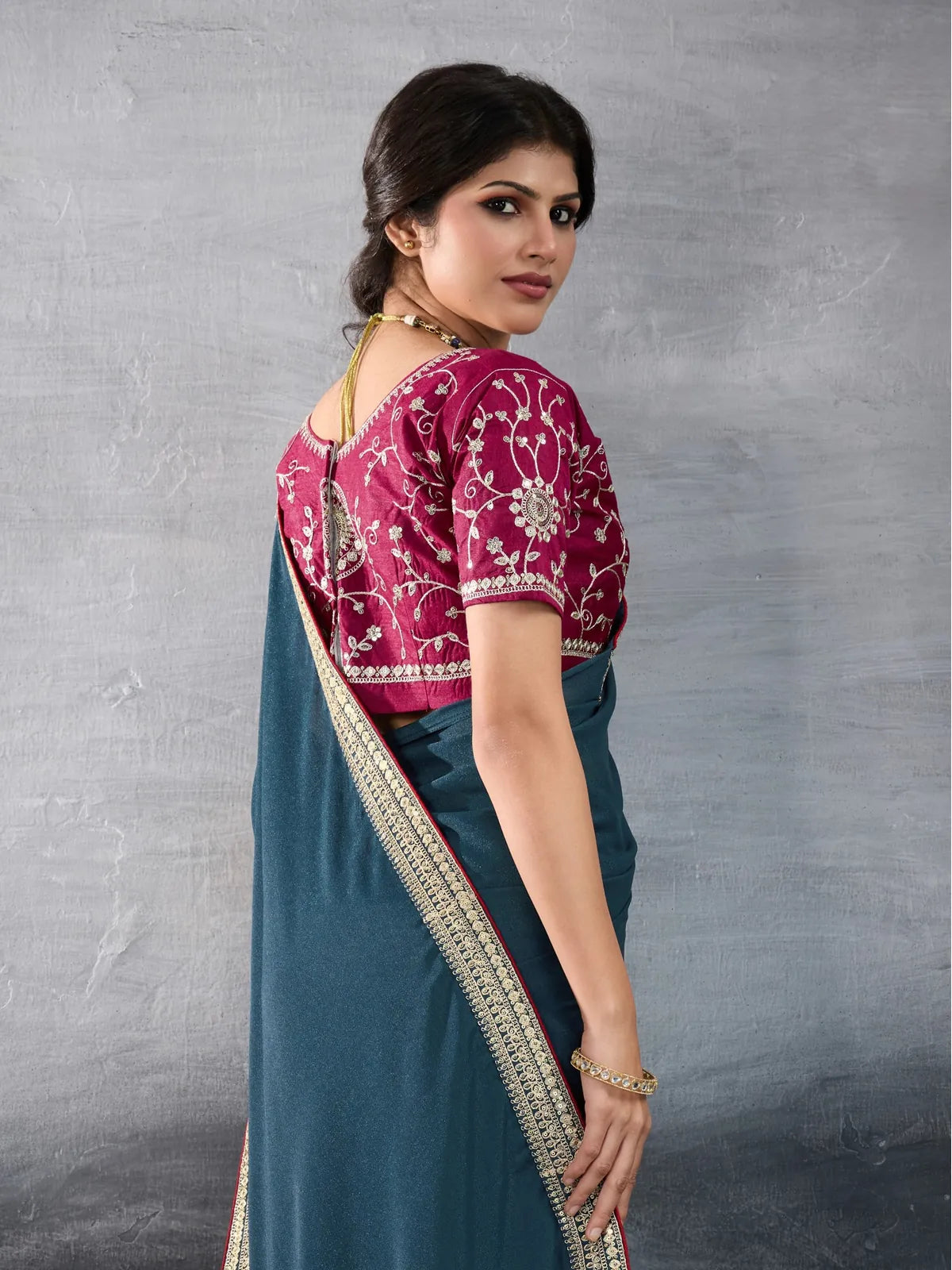 Tarani teal georgette saree back view showing detailed blouse embroidery