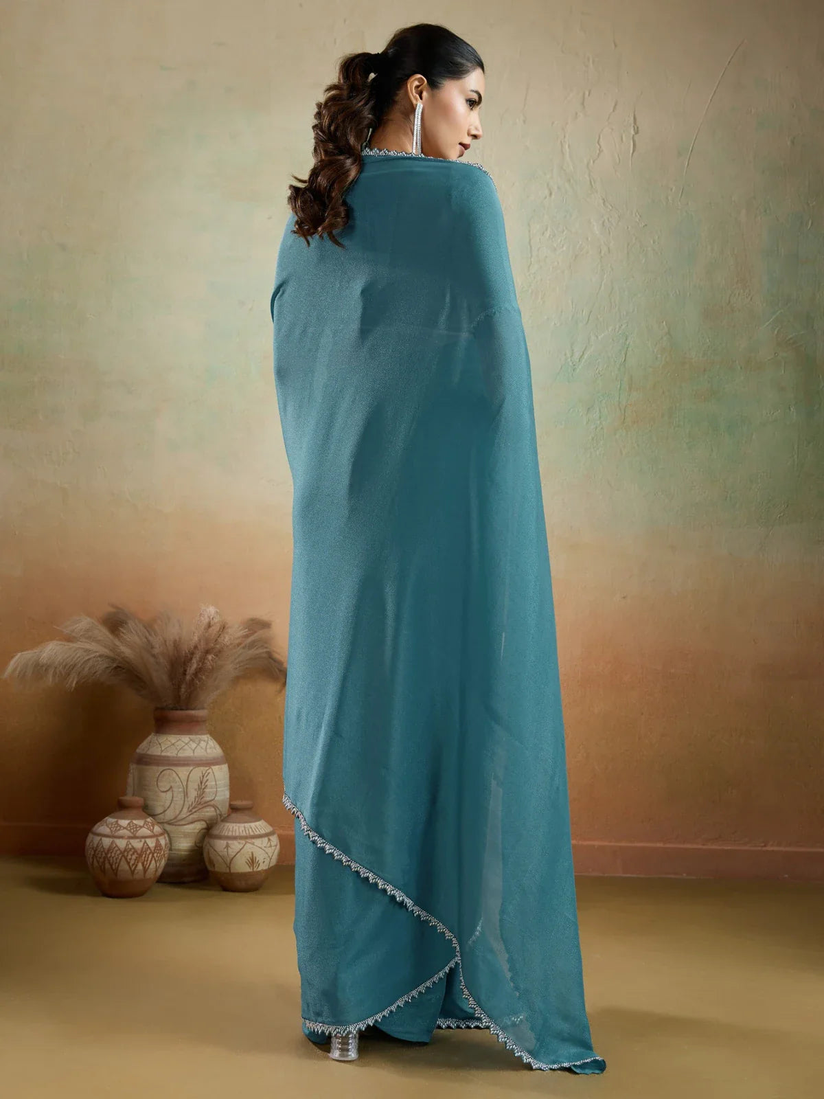 Tarani teal georgette saree with lace work elegant back view