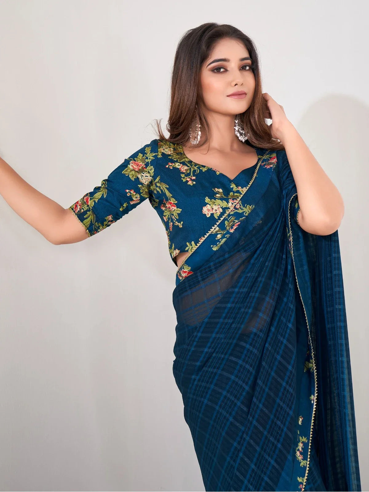 Tarani teal blue georgette saree close up upper body view highlighting floral blouse design