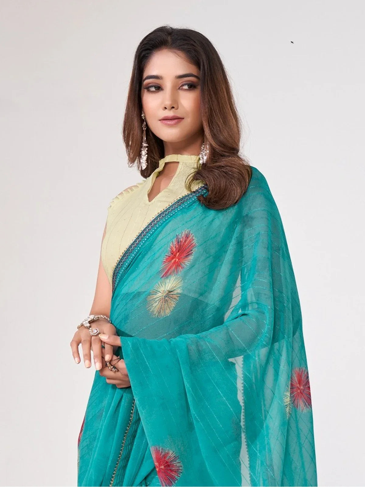 Tarani teal georgette saree upper body view highlighting soft drape and floral embroidery