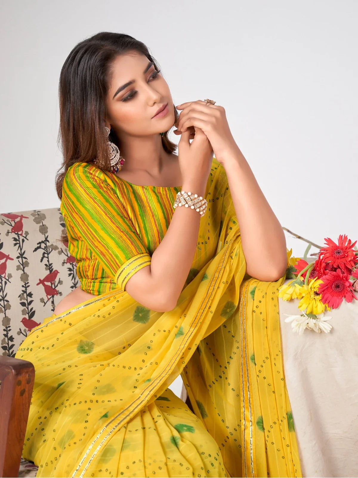 Tarani yellow georgette saree festive look with elegant drape and green motifs
