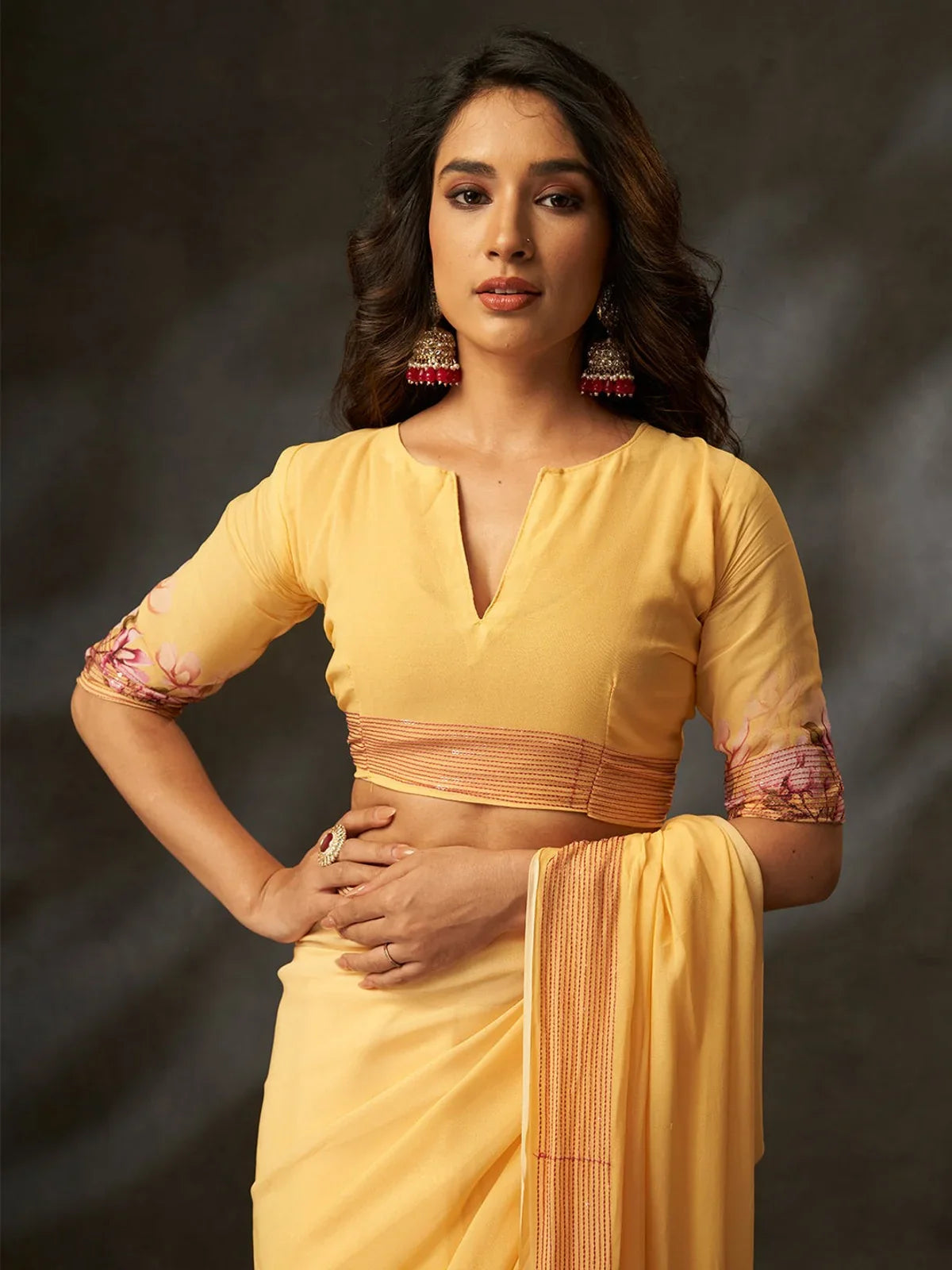 Tarani yellow georgette silk saree with elegant blouse closeup and floral sleeve detail