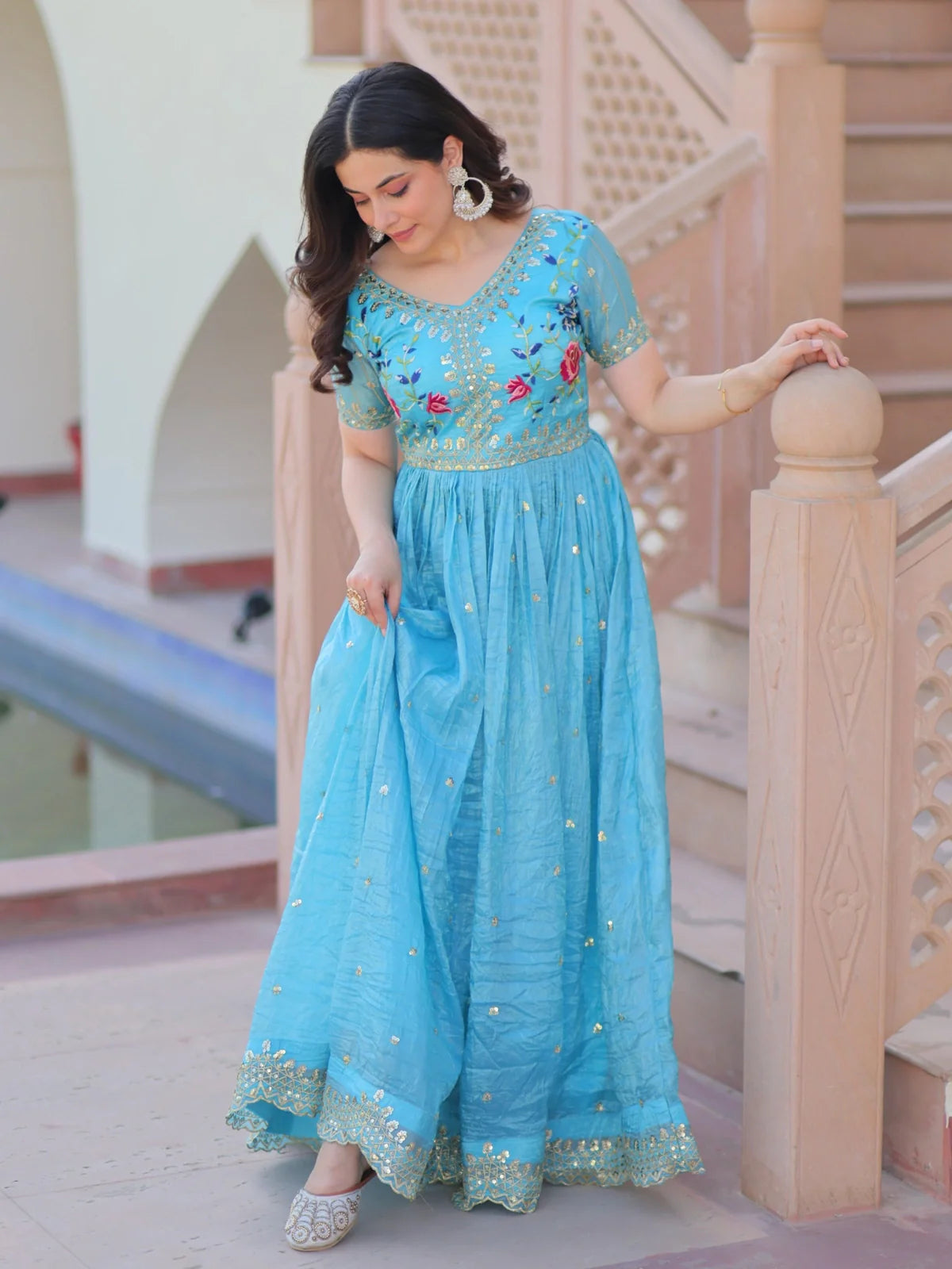 Tarani blue gold crush gown side view highlighting elegant flair and embroidery work