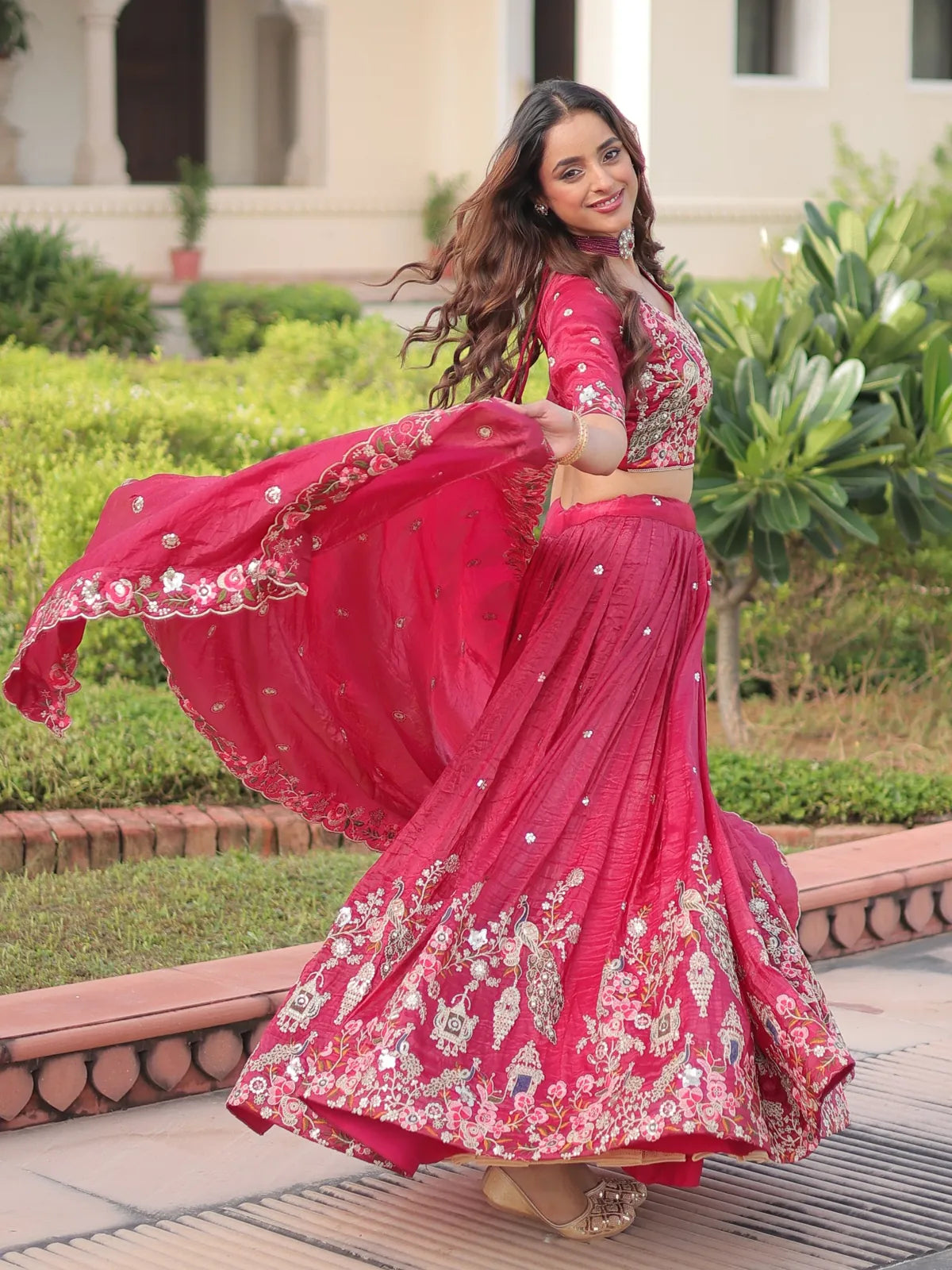 Tarani pink lehenga pallu twirl view showing zari border and ethnic motifs with graceful drape