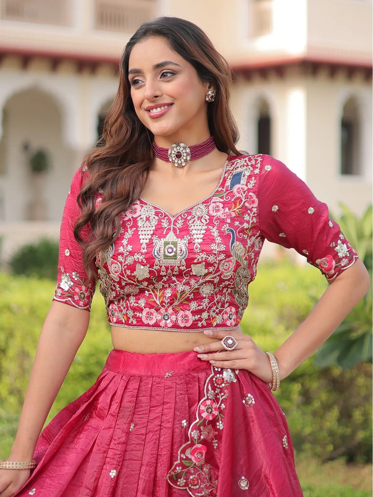 Tarani designer pink lehenga close-up showing embroidered blouse with choker styling and soft waves