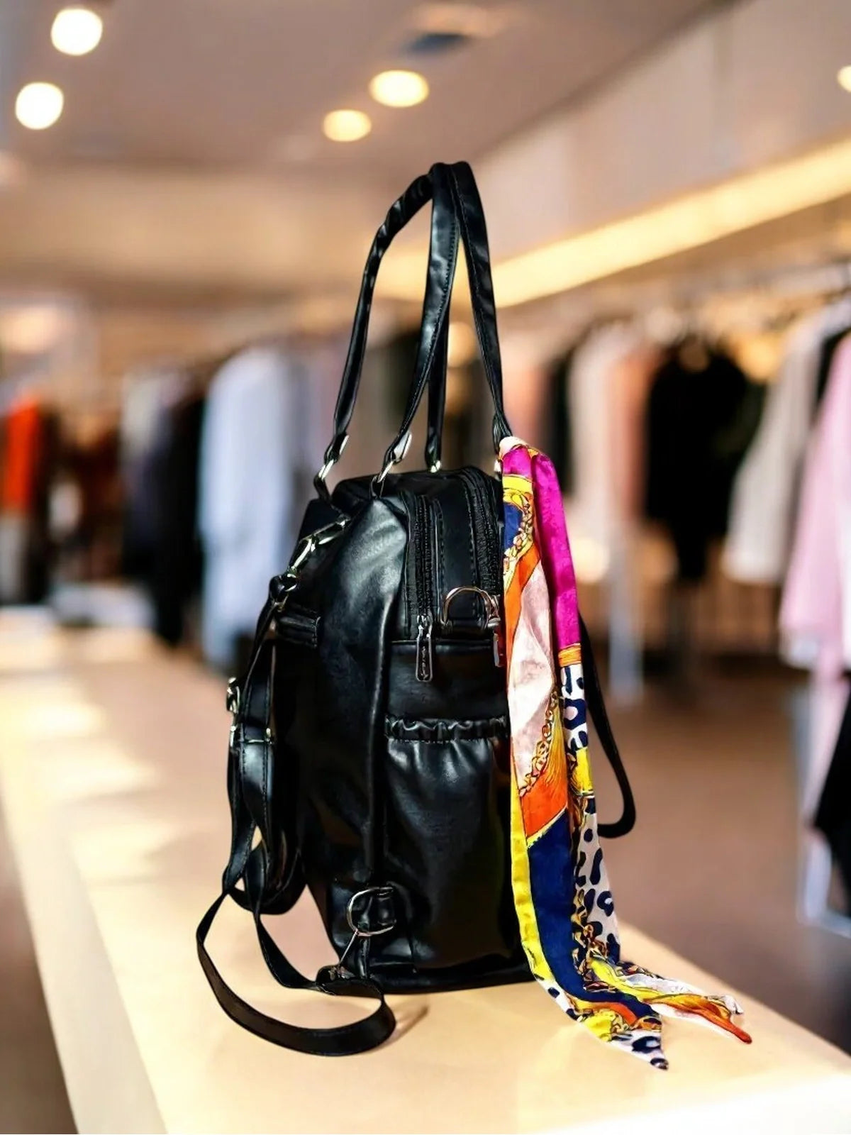 Tarani black PU leather handbag side view with straps