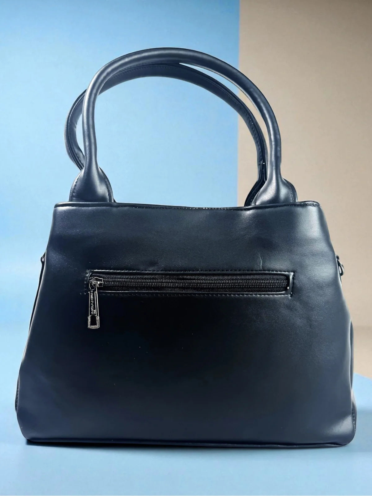 Tarani black PU leather handbag back view with zipper pocket