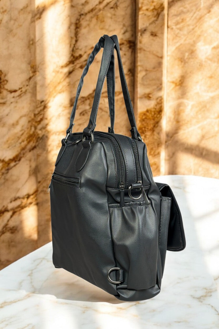 Tarani black PU leather handbag side view with metal rings