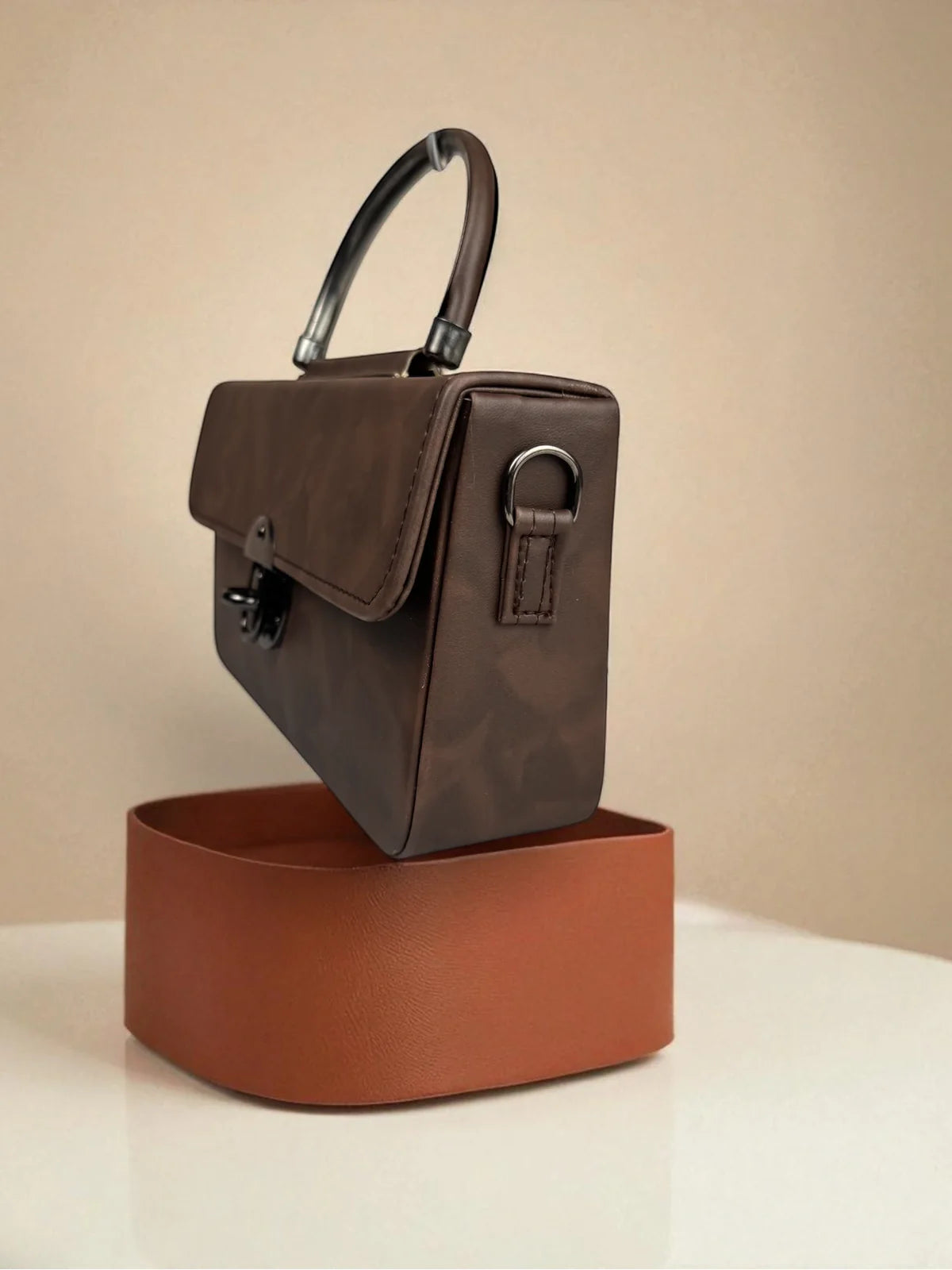 Tarani brown PU leather handbag side angle showcasing handle and design