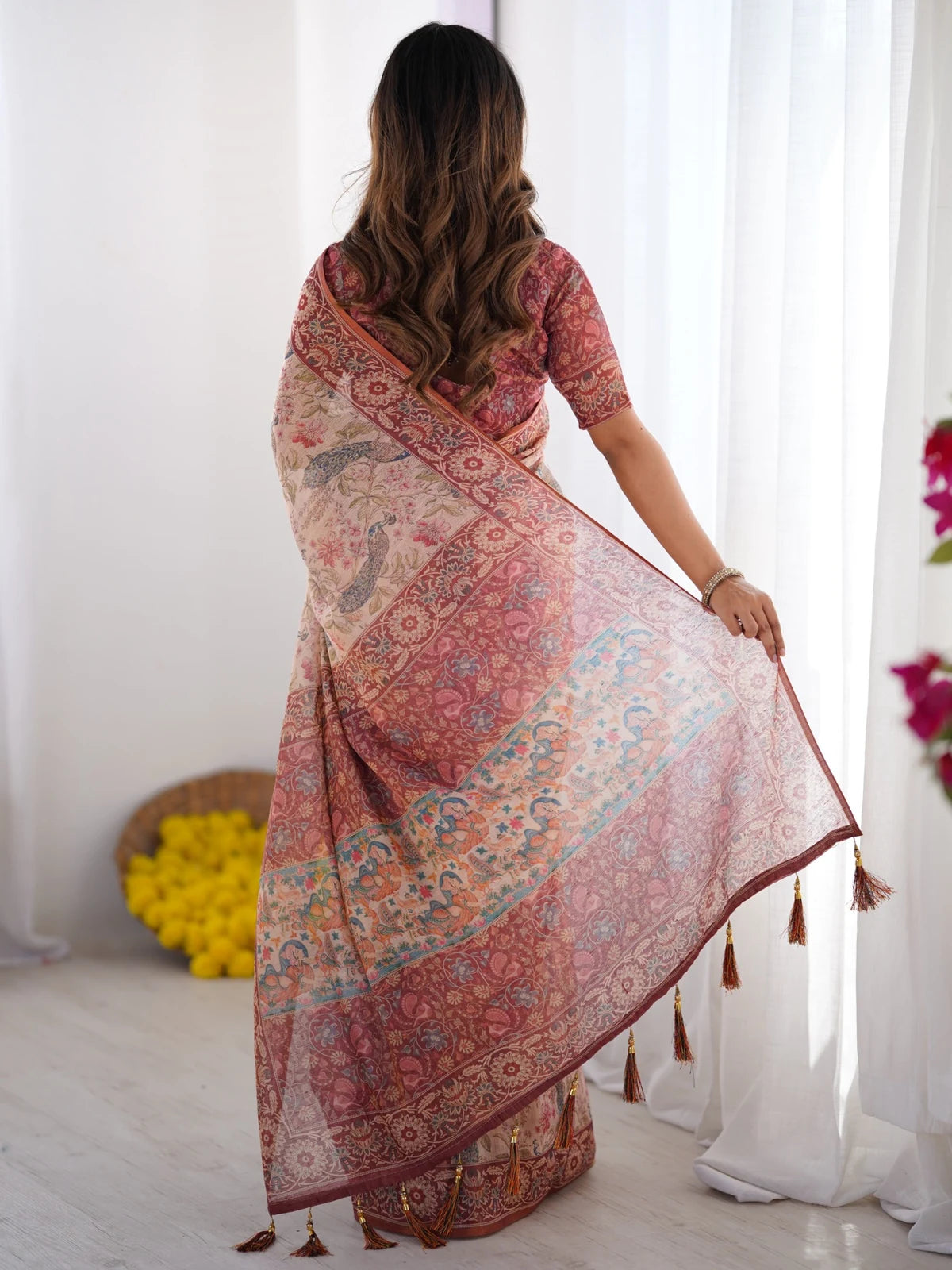Tarani Vaishvika premium handloom beige saree back view with artistic pallu and tassels