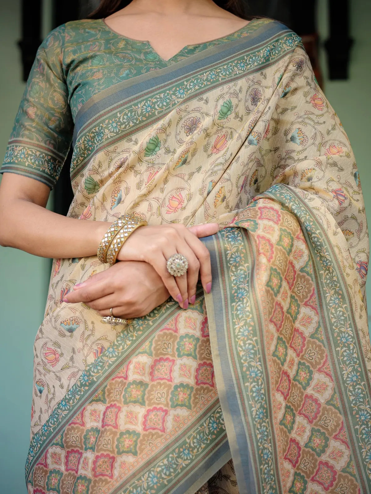 Tarani Vaibhavi premium handloom beige saree closeup showing floral motifs woven border and detailing