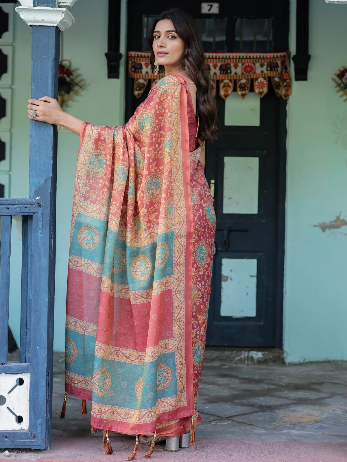 Tarani peach premium handloom saree back view with artistic pallu and tassel detailing