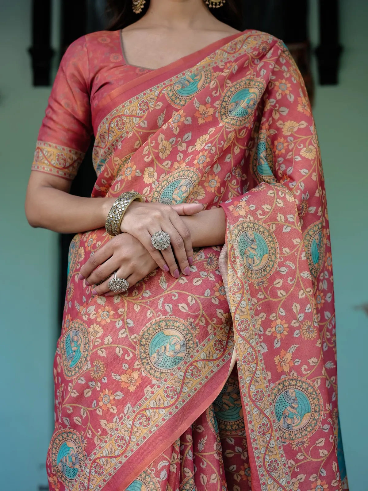 Tarani peach handloom saree closeup showing floral motifs heritage medallions and elegant border