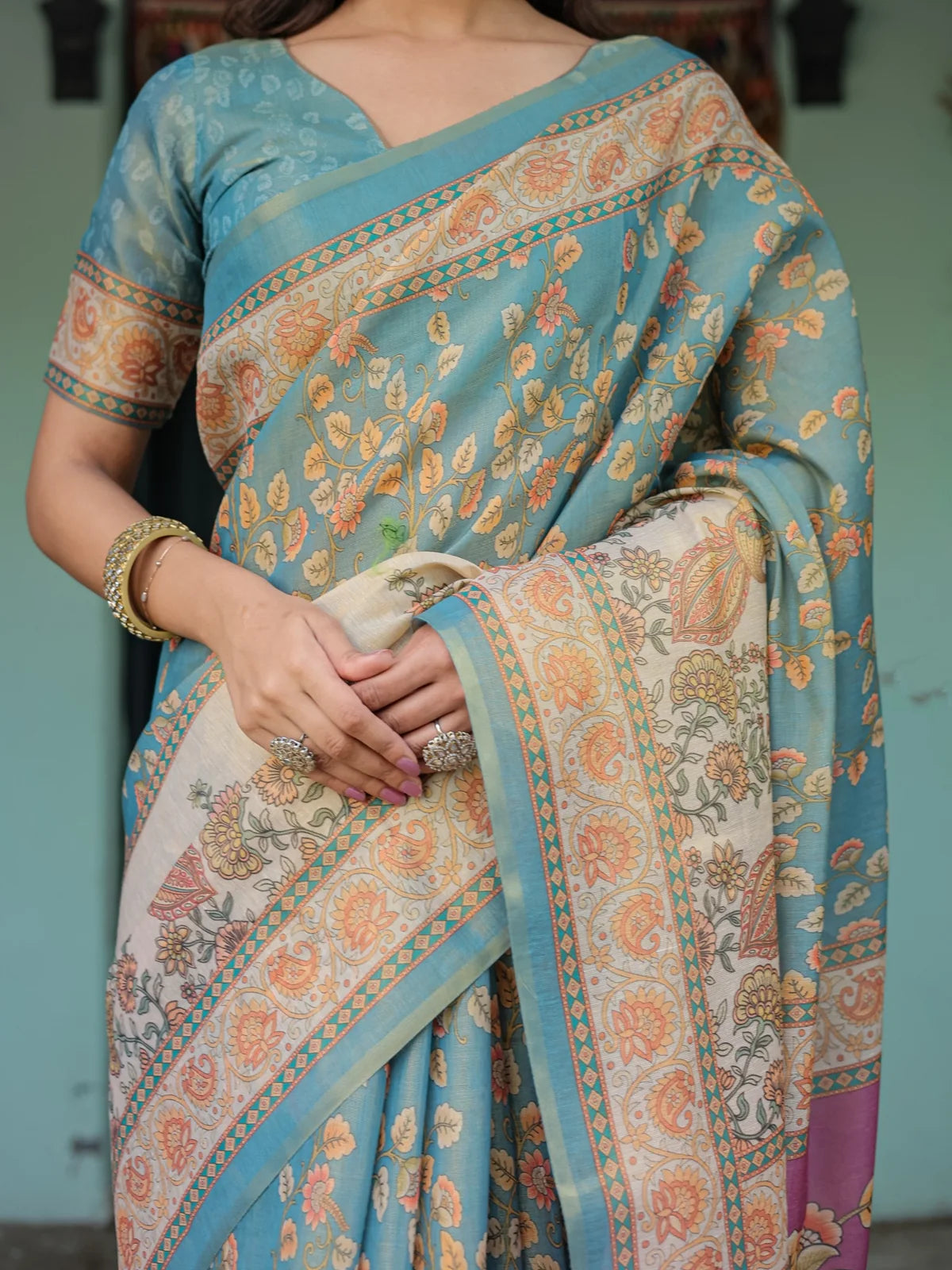 Tarani teal premium handloom saree closeup view showing floral weaving and heritage border Lipisha