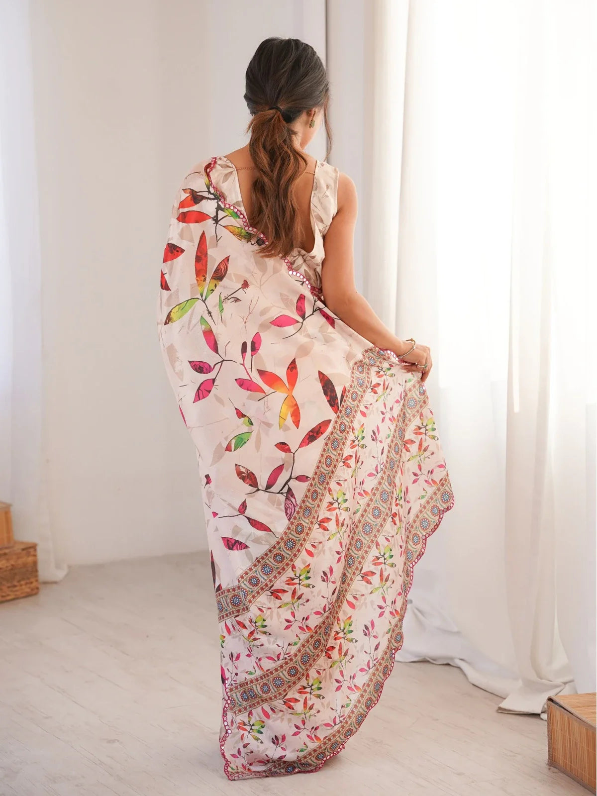 Tarani back view of model in pink Chinnon saree with mirror lace and floral motif print