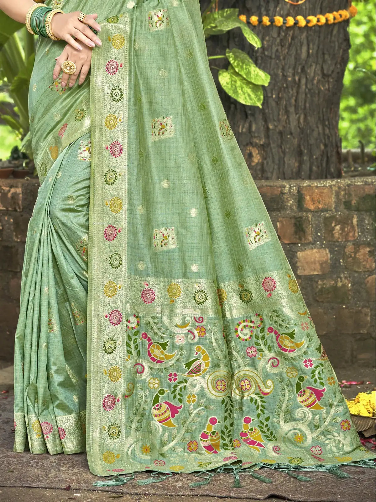 Tarani green Kanan silk saree close up showing bird motifs floral weaving and zari border details