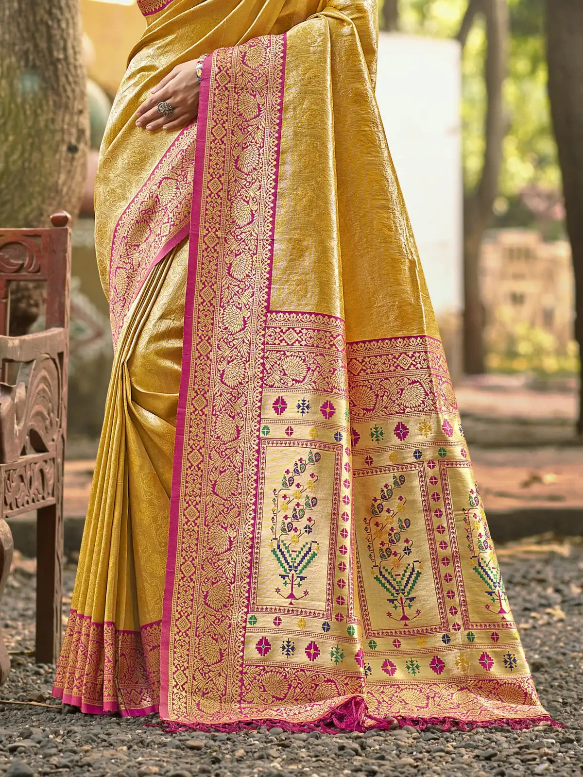 Tarani yellow Kanjivaram silk saree closeup showing intricate woven pattern and texture