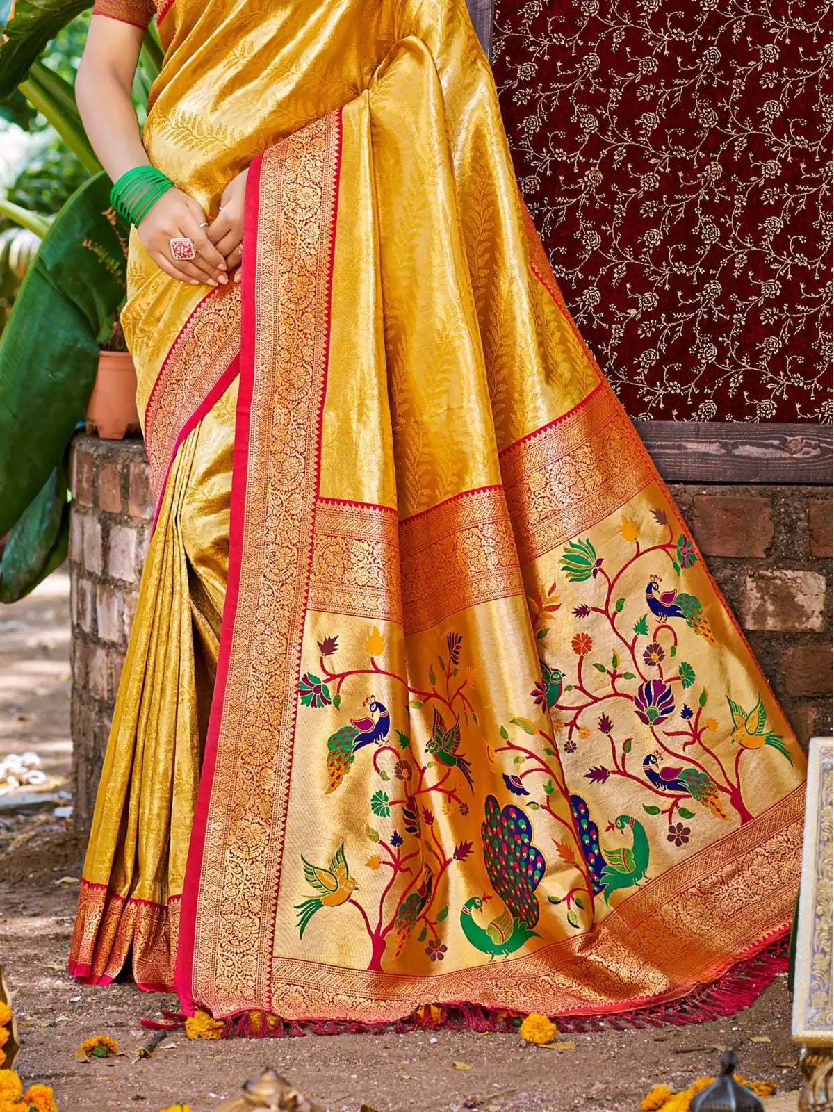 Tarani yellow Kanjivaram silk saree pallu view with intricate peacock woven motifs and golden shine