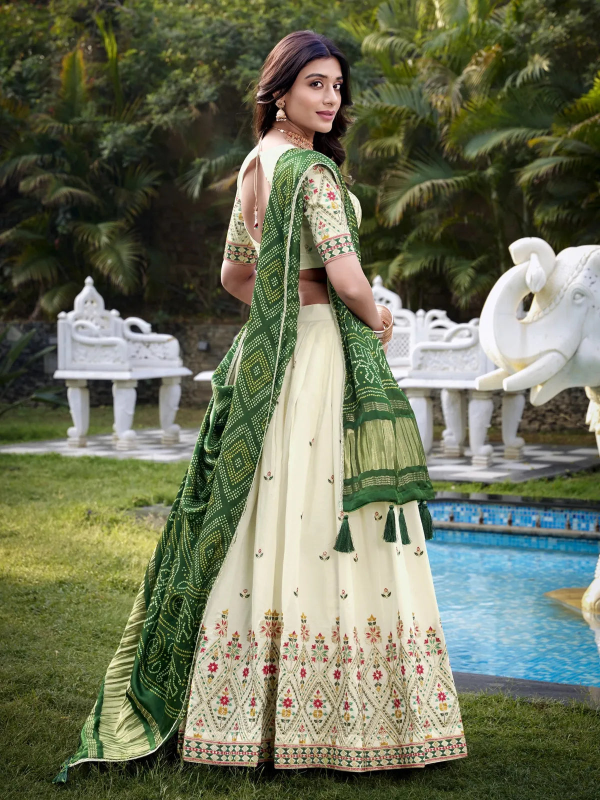 Tarani cream lehenga back pose with blouse design and detailed dupatta view