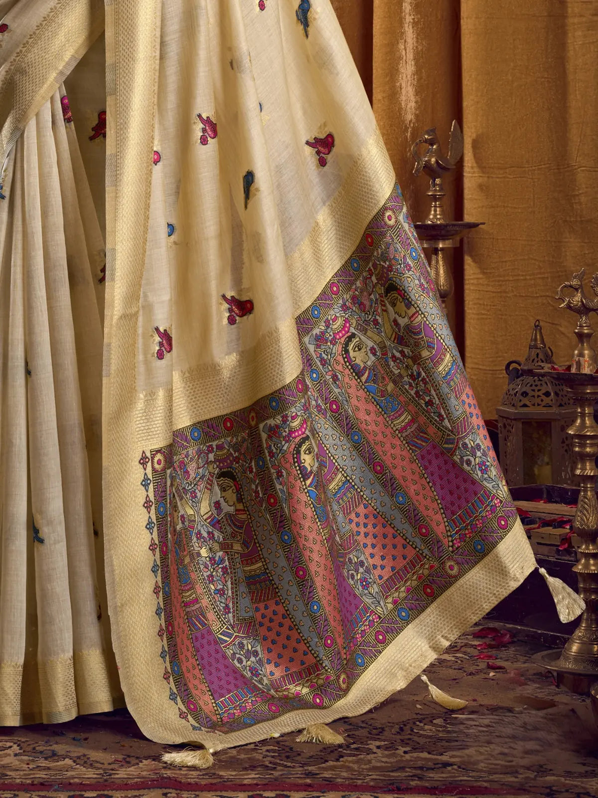 Tarani pallu view showcasing hand-drawn mithila art design with tassel detailing in beige khadi saree